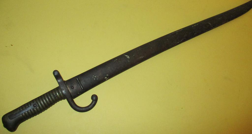 Antique French Bayonet: Lot consists of an antique French bayonet, approx. 26" inches long with scabbard. In fair condition.