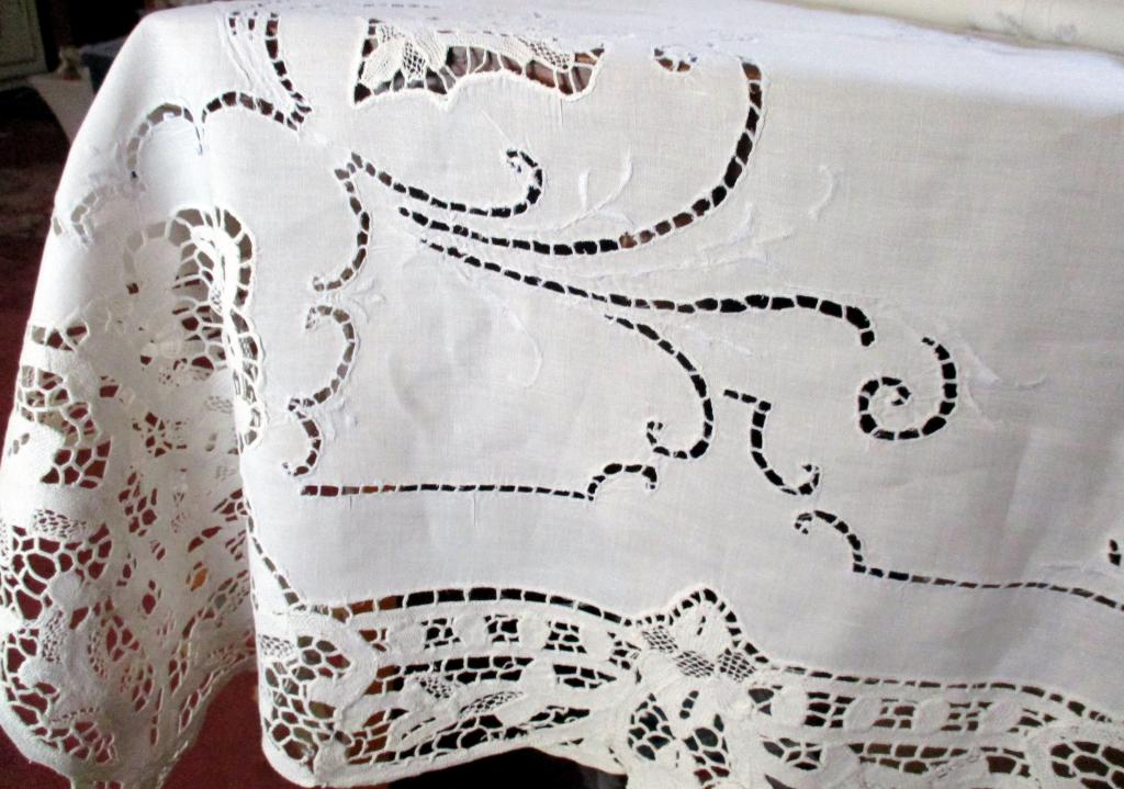 Italian Cut Work & Crochet Table Linen: Lot consists of an Italian cut work & crochet table linen. In very good condition. Approx. size is 94" inches long by 64" inches wide.