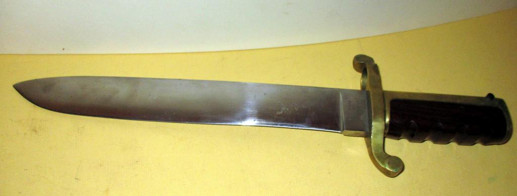 USN Bayonet by Ames, Chicopee MA: Lot consists of a USN bayonet by Ames Co. of Chicopee, MA. Has a brass and wooden grip. It measures approx. 17" long.