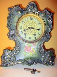 Porcelain Victorian Mantle Clock: Consists of a Porcelain Mantle Clock with a Pendulum and Key. Made by the Waterbury Clock Co., Waterbury CT. Circa 1900. No Chips or Cracks, Seems to be Working. Size is Approx. 11" inches tall by 9"