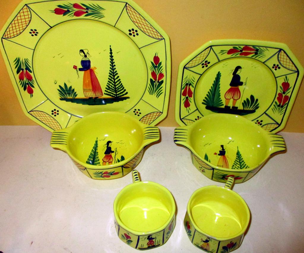 Miscellaneous Lot of Quimper: Lot Consists of 2 Teacups, a Dinner Plate, a Dessert Plate and 2 Soup Bowls. All in the Yellow Color. All in Fair to Good Condition. One of the Cups has a Minor Bit of Glaze Roughness Next to the Hand