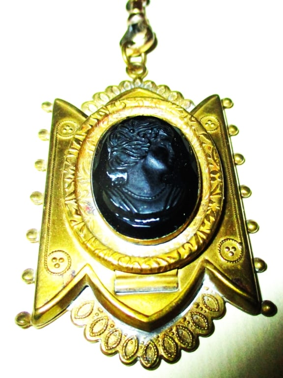 Victorian Locket with Black Onyx Cameo: Lot Consists of a Victorian Pendant with a Double Neck Chain. It is Set with a Black Onyx Cameo. In Good Condition. Most Likely Gold Filled. Chain is Approximately 20" inches Long
