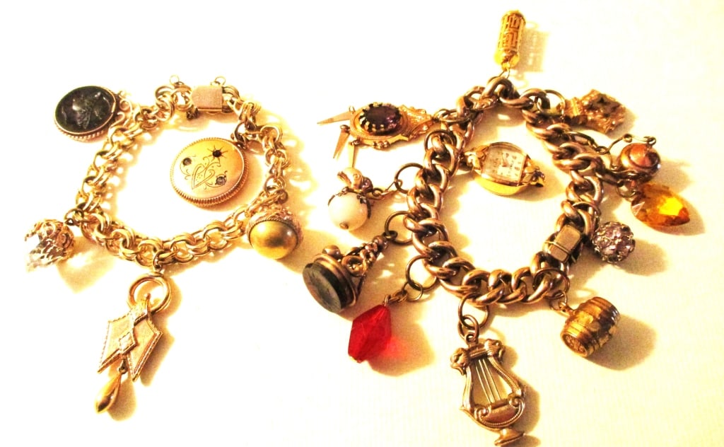 Two Gold Filled Charm Bracelets: Lot Consists of 2 Gold Filled Charm Bracelets. One Bracelet is Approximately 6 1/2 " inches Long with 11 Charms. The Smaller one is Approximately 6" inches Long with 5 Charms, one of which is an Intag