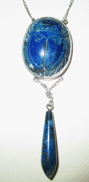 Lady's Vintage Lapis Necklace: Lot Consist of a Lapis Pendant in the Motif of an Egyptian Scarab on Silver Chain. The Color is Blue with a Drop Bead at the Bottom. Approximate Length is 16" Inches.