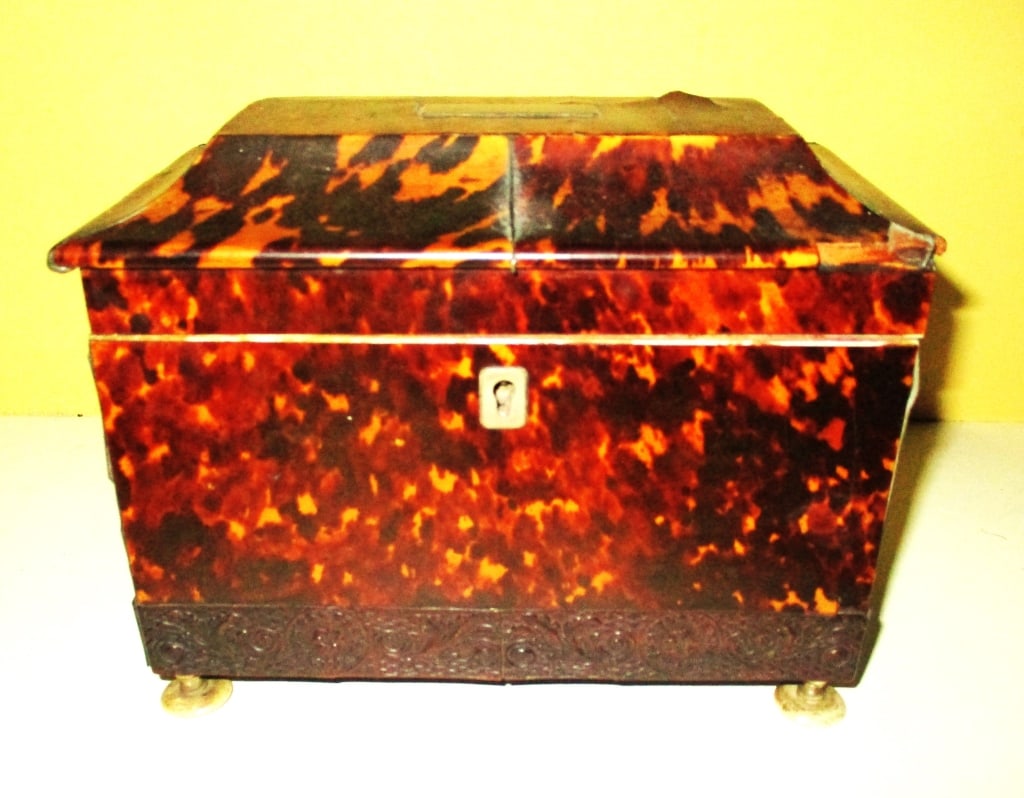 English Veneer Tea Caddy: Lot Consists of a Federal Veneer Tea Caddy. Approximate Size is 6" Inches Tall, 7" Inches Long and 4" Inches Deep. The Condition is Poor and Could be Restored. One of the Feet Doesn't Match the Other 