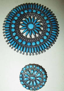 Two Sterling Brooches Set with Turquoise: Lot Consists of 2 Sterling Brooches Set with Turquoise Stones. One is Large in Size with an Approximate 3" Diameter. The Smaller Brooch Has a 1.25" Inch Diameter. The Have the Same Design. Both