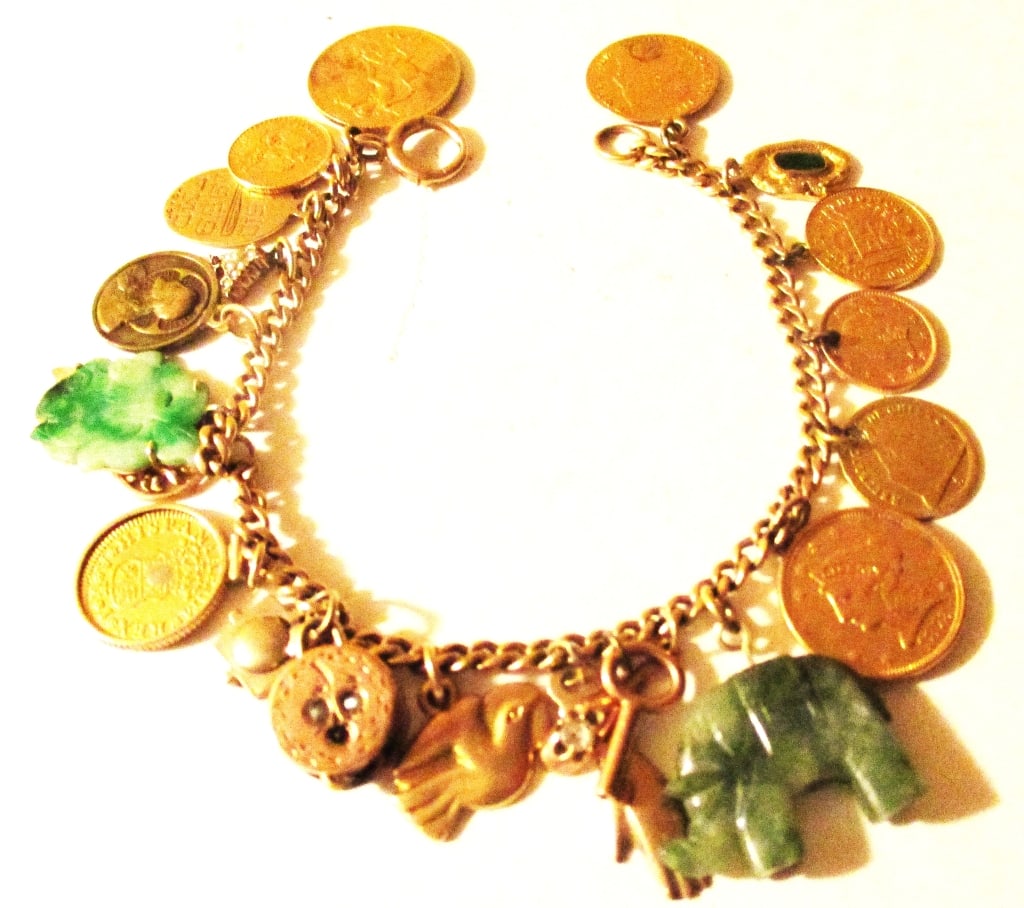 Gold Coin Charm Bracelet: Lot Consists of a Gold Bracelet Made With Gold Coins and Mixture of 14K/10K Gold Charms. There are a Couple of Jade Charms, Mixture of English, French, American & Spanish Coins. One Spanish Coin is