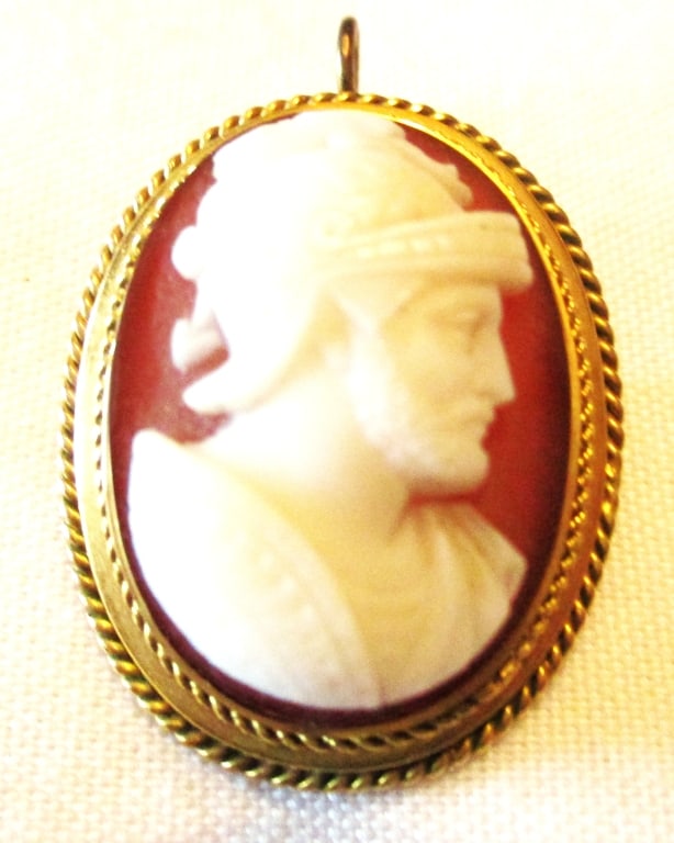 Victorian Cameo of a Roman Soldier: Lot Consists of a Pendent / Brooch With a Stone Cameo of a Roman Warrior. Approximately 1 1/2" Inches Long by 1" Inc Wide. Set in a 10K Gold Bezel. Approximate Weight is 7.1 dwt. In Good Condition.