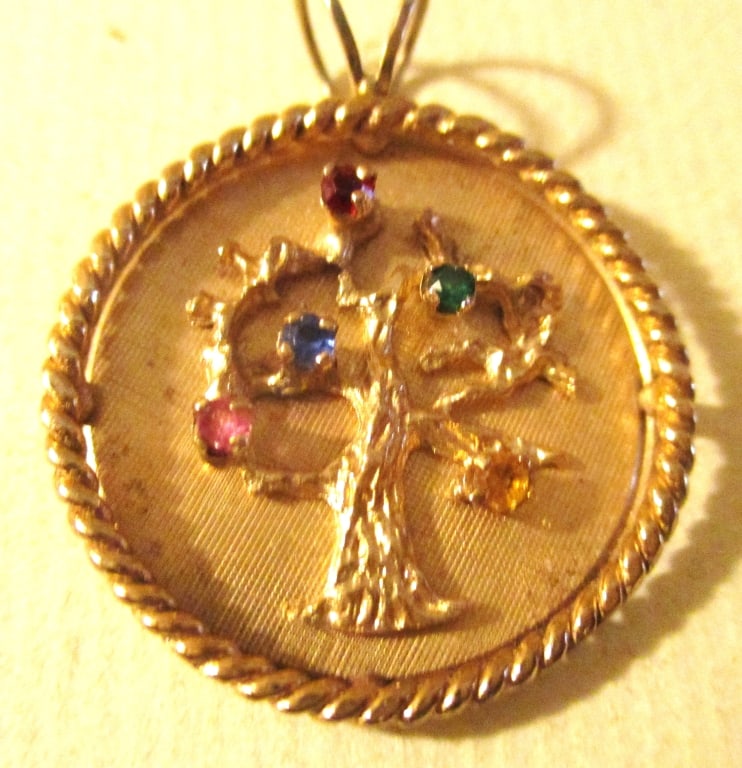 14K Gold Mother's Pendant: Lot Consists of a 14K Gold Mother's Pendant. The Pendant Has a Motif of a Tree Set With Semi Precious Stones Representing a Mother's Children. The Approximate Weight is 3.6 dwt. In Good Condition.