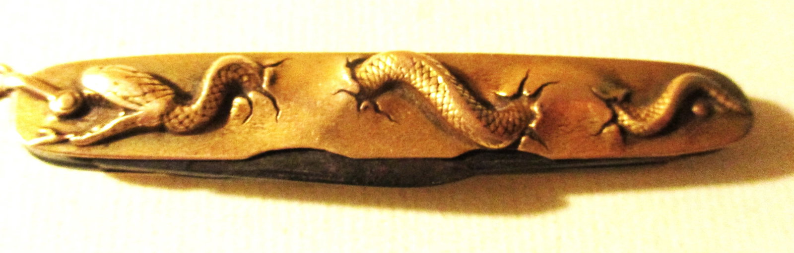 14K Gold Jackknife Pocket Watch Fob: This lot consists of a 14k Gold jackknife pocket watch fob, It is made by and signed by George Wostenholm in Sheffield England. This knife, has a motif of a snake slithering across each side, It has 3
