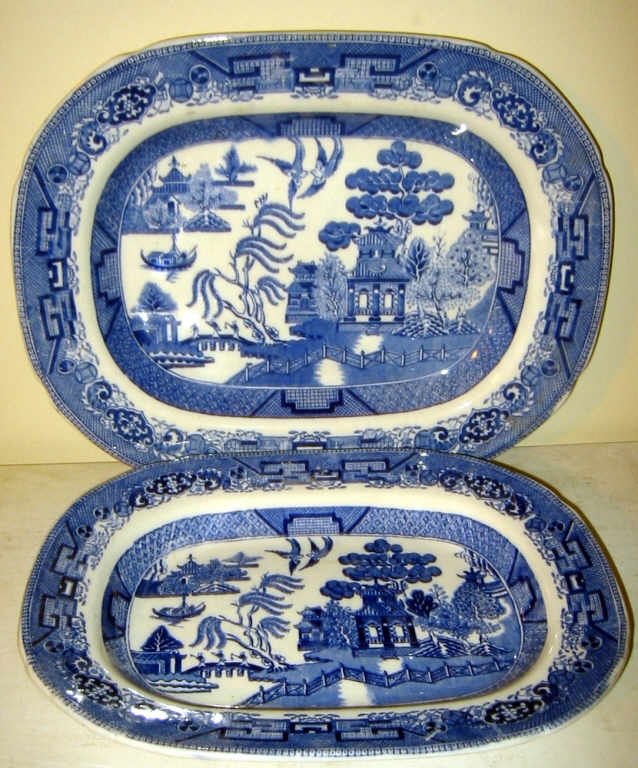 Two Old Willow Ware Platters: One platter is larger than the other. Sizes are 13 1/2" X 10" and the other is 9" X 12". Both in good condition.