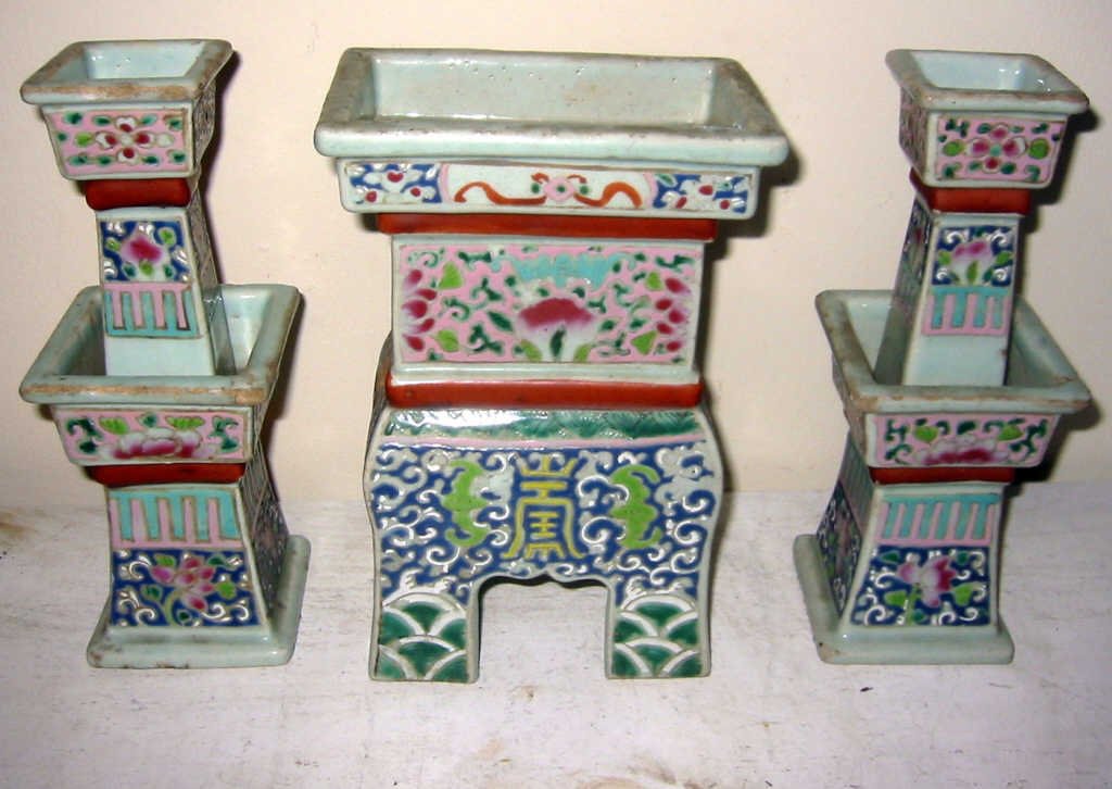 Three Piece Chinese Porcelain Shrine Set: Shrine set consisting of two porcelain candlesticks, one of which has a hairline crack and an incense vase in fair condition, 20th century.