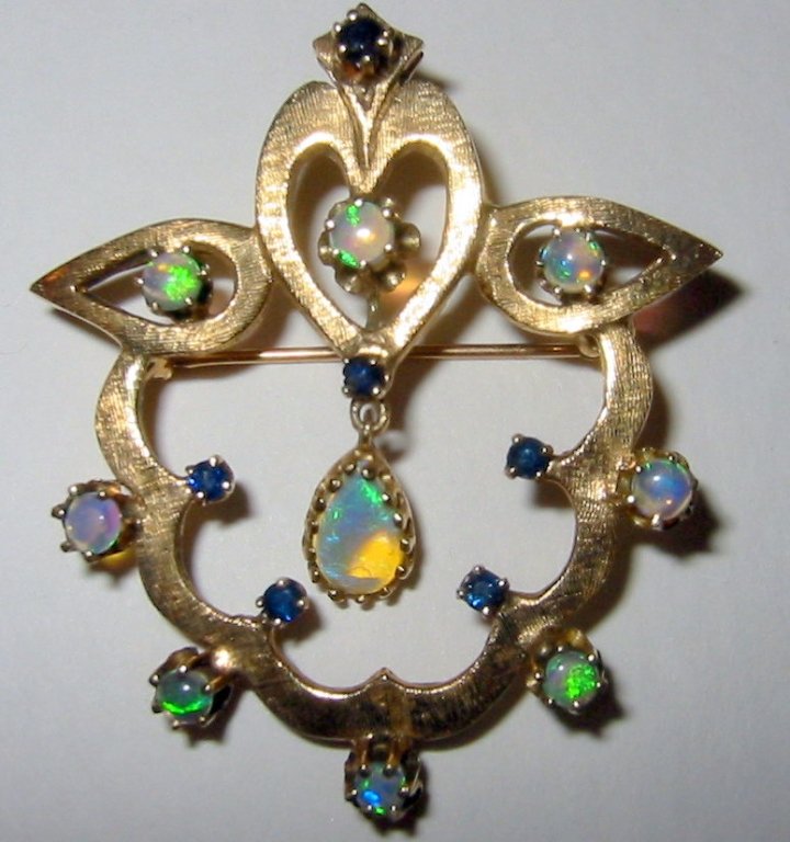 Edwardian Brooch with Pendant in 14k Gold: Edwardian 14k gold brooch which can be worn as a pendant, set with sapphires and opals with a larger center opal hanging. Signed by the maker but not legible.