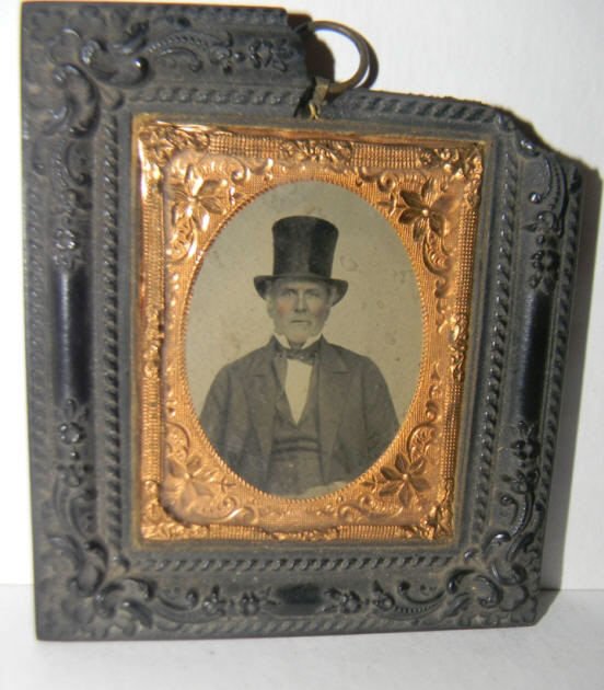 Daguerreotype of Man with Top Hat: Daguerreotype of a man wearing a top hat set in a gutta percha frame. Frame has damage on one end, dagguerreotype/ambrotype is in good condition.