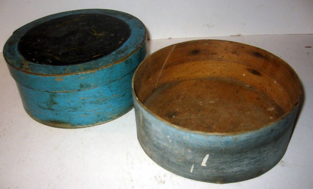 Lot of Two Pantry Boxes: Two pantry boxes in original blue paint. One has a missing cover, they are not shaker in origin. Each is 6 1/2" in diameter.