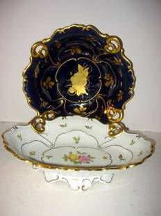 Two German Porcelain Bowls: One cobalt and gilded serving bowl and one porcelain gilded footed center bowl. Both in good condition. Diameter on cobalt - 11" and oval 12" across.