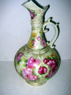 Hand Painted Porcelain Ewer: Hand painted porcelain ewer, most likely unsigned Nippon. Rose motif and is 13" tall, in good condition.