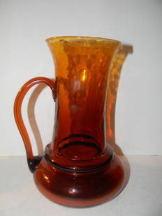 Hand Blown Amber Glass Pitcher: Beautifully formed hand blown amber glass pitcher, in very good condition. 9 3/4" tall.