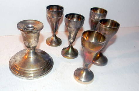 Lot of Sterling Silver Items: Lot of five sterling shot cups and one weighted candlestick. Lot in good condition.