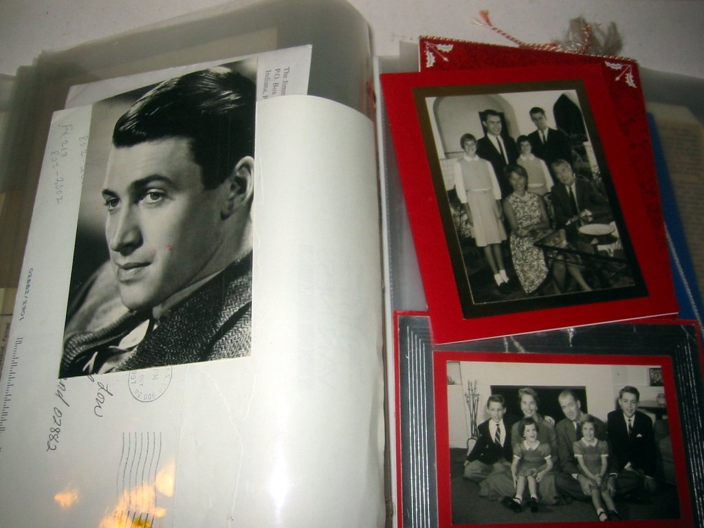 Large Album of Jimmy Stewart Memorabilia: Large album of doctor James Stewart filled with letters ad correspondence as well as family photos, air force documents, etc. Cards and letters signed by Jimmy Stewart, all in very good condition.