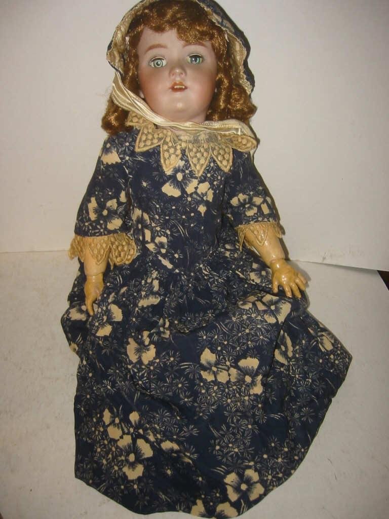 German Antique Doll with Bisque Head: German "Handwork" doll, 20" long. No cracks but missing one leg from knee to foot. Antique outfit but has pierced ears and one eye does not open and close. Fair poor condition.