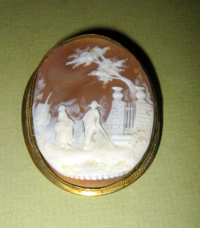 Scenic Shell Cameo in Gold Filled Frame: Scenic shell cameo of 18th century couple in good condition. Needs to be reset. 2" x 1 1/2" wide C.a. 1890.