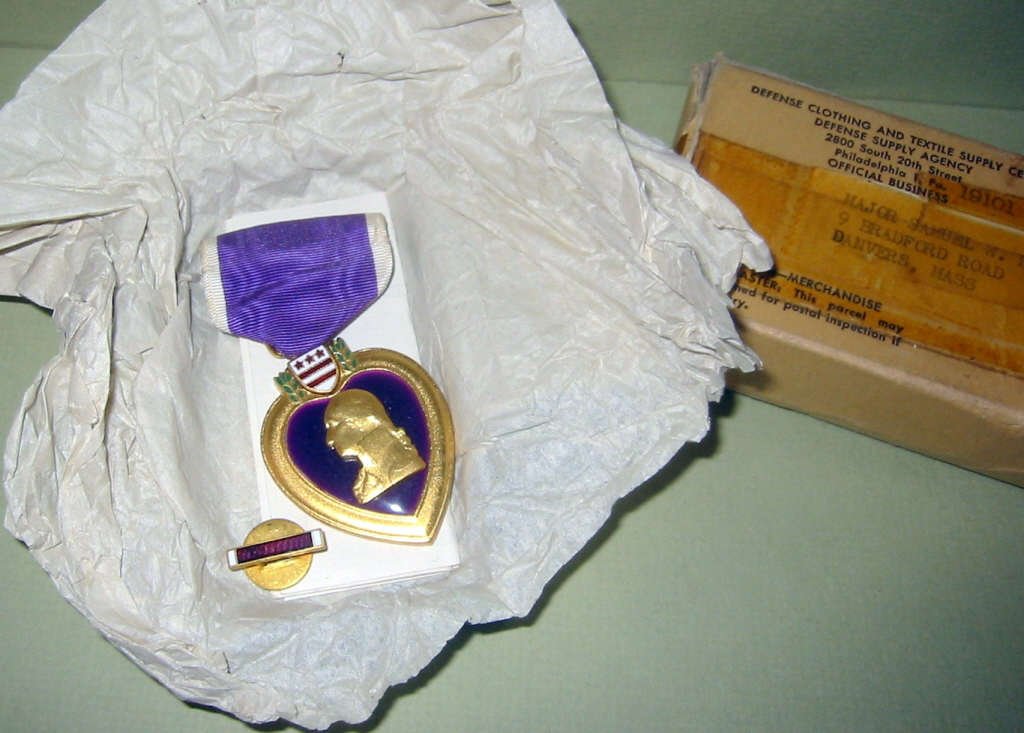 WWII Purple Heart Medal: WWII Purple Heart medal engraved with the recipient's name on back (Major Samuel W. Riley) from Danvers, MA. In very good condition along with lapel button, paperwork, and box.