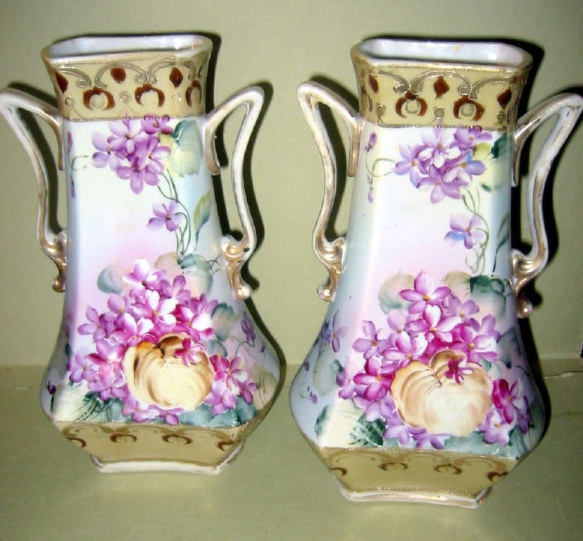 Pair of Hand Painted Nippon Vases: Pair of hand painted Nippon vases, floral motif with handles in fair to good condition, 9 1/2" tall.