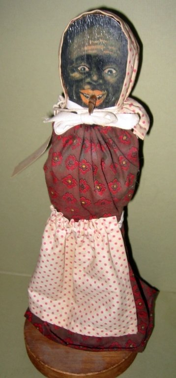 1920's Ring Toss Doll: 1920's Ring Toss doll with black face and dowel protruding from the mouth which a child would toss rings on to it. Clothing was replaced early on, dowel is broken off.