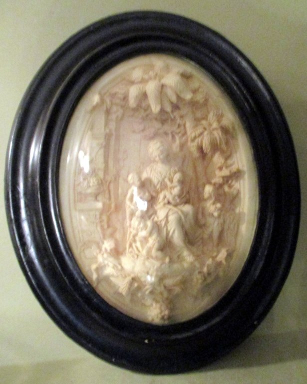 Victorian Plaster Relief under Dome Glass: Victorian religious plaster relief under dome glass. Glass has a crack which doesn't go across. Relief is beautifully done. Measures 15" tall and 12" wide.