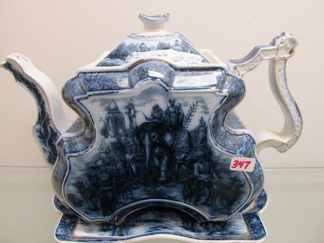 VERY RARE Flow Blue teapot depicting men riding El: VERY RARE Flow Blue teapot depicting men riding Elephant in a Middle East market. men riding Elephant in a Middle East market.