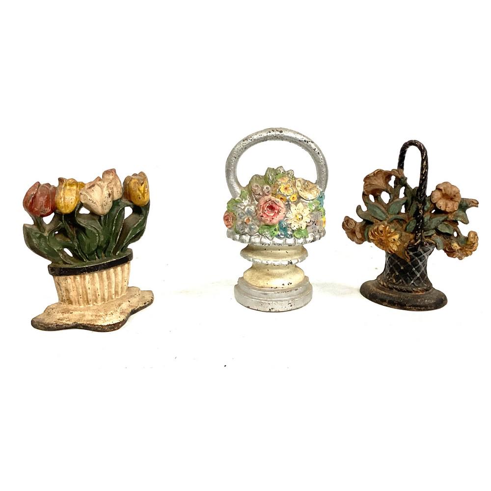 Three Cast Iron Doorstops Floral: Three Cast Iron Doorstops Floral