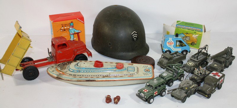 Toy lot with tin boat, army cars and plastic helm: Toy lot with tin boat, army cars and plastic helmet and toys in original boxes