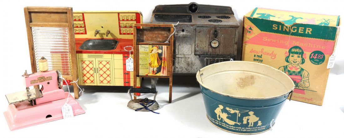 Singer sewing machine "Sew Handy" in original box: Singer sewing machine "Sew Handy" in original box made in Great Britain, Kay Sew Master 8" w x 7" h pink, metal stove 12" h x10 1/2" w black and silver, tin sink by Wolverine 10 1/2" w x 10" h red and