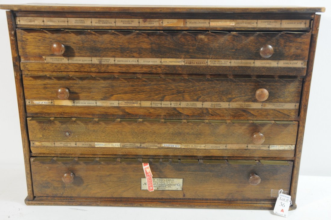 Oak Four Drawer Cabinet that holds 74 Roll Labels b: Oak Four Drawer Cabinet that holds 74 Roll Labels by the McCourt Label Cabinet Co Bradford PA 33"x 16 1/2" H one drawer missing a knob.