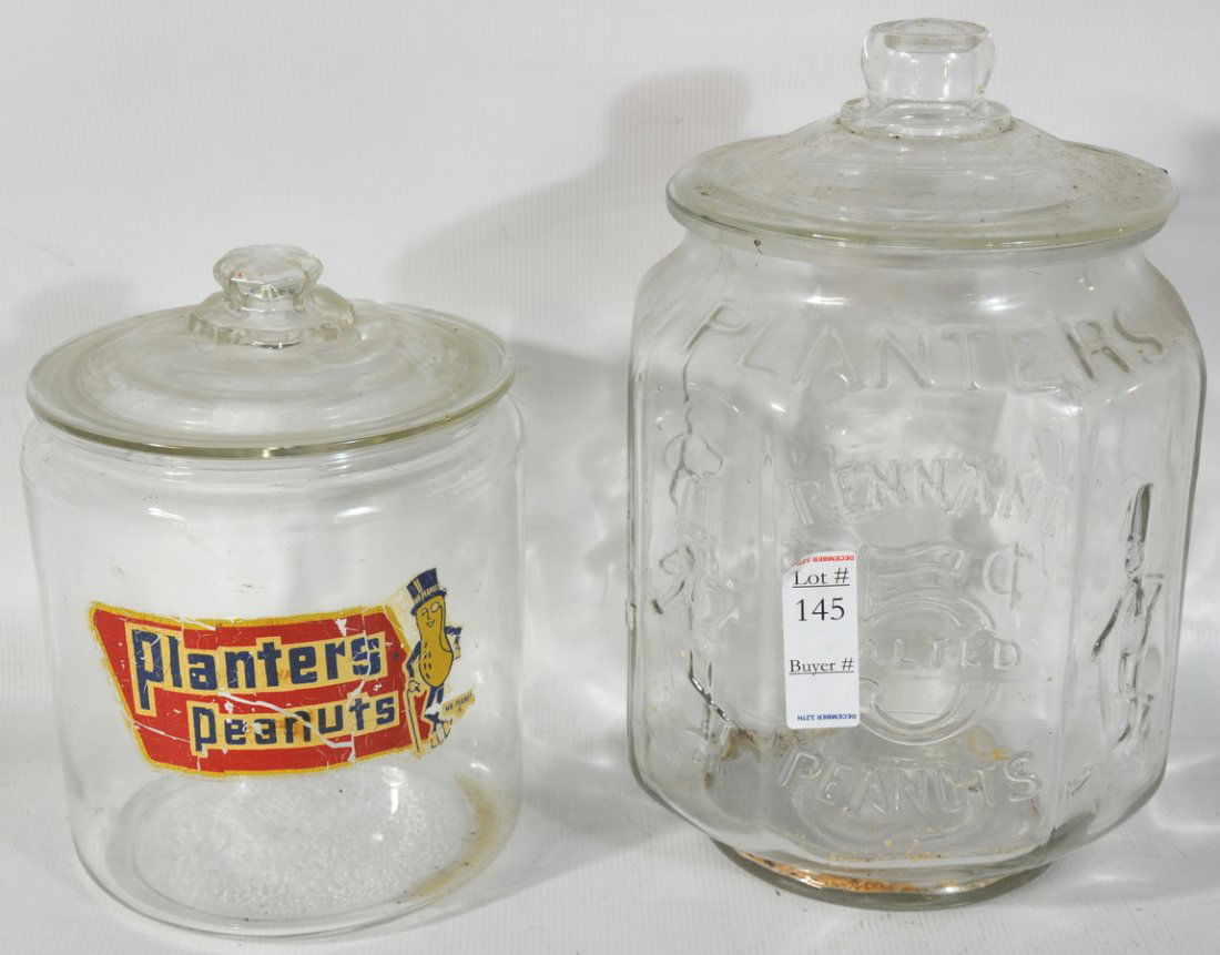2 Planters Peanut Jars: 2 Planters Peanut Jars, 1 Has Original Label 7" X 10 and the Other Embossed 5 Cents and Logo 8" X 13" Both With Covers