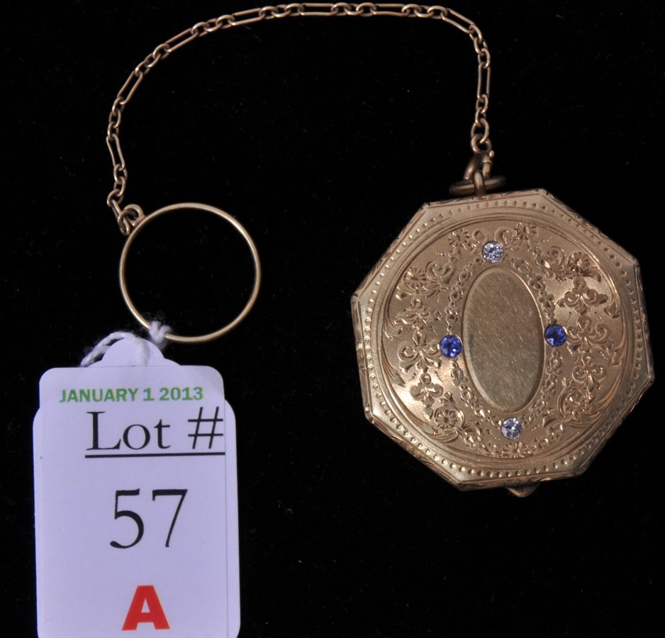 Tiffany and Company Compact: Antique Tiffany and Company 14Kt. Mini Compact with finger chain set, cover adorned with diamonds and sapphires weighs 29 DWT with pad and mirror 1 1/2"x1 1/2" Octagonal shaped, is not monogrammed
