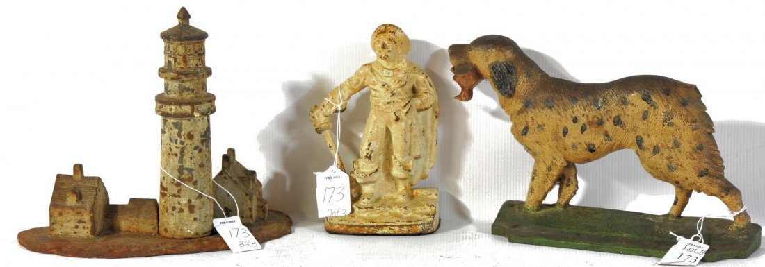 Antique Door Stops: Three antique door stops including an unusual Highland Light Cape Cod, Dog and pirate