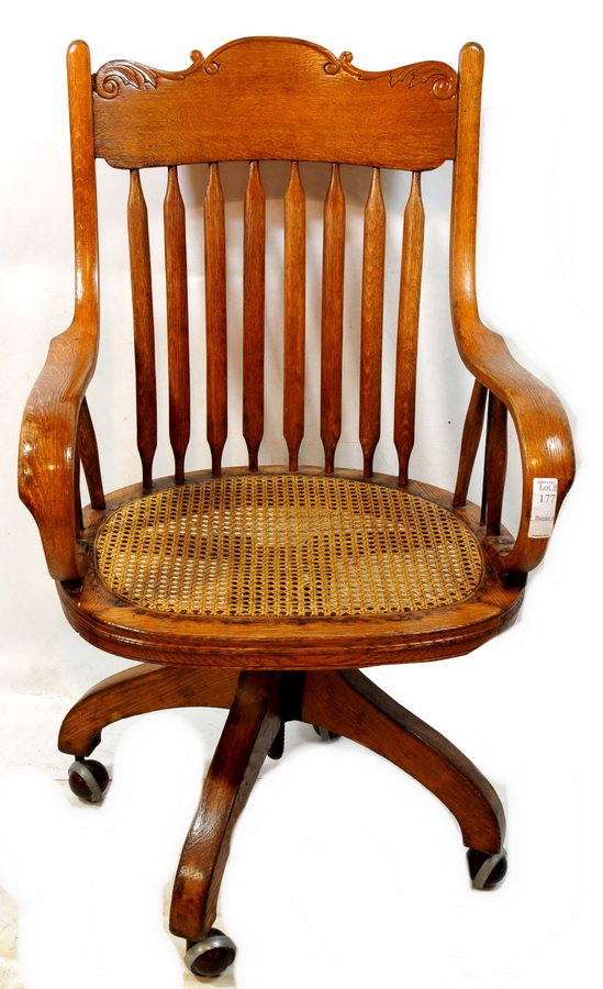 Oak caned office chair on castors 39 1/2 x 22 1/2 x 20.: Oak caned office chair on castors, 39 1/2 x 22 1/2 x 20.