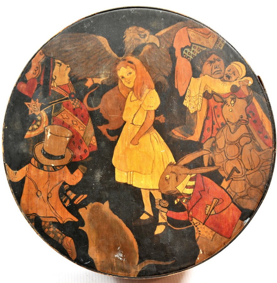 Covered oval box hand painted(T2): Covered oval box hand painted cover depicting "Alice in Wonderland" scene hand painted cat, rabbit, and mushroom on box, contents of box to include 5.1/4" fingered oval box, 3 darning bobs, and wooden