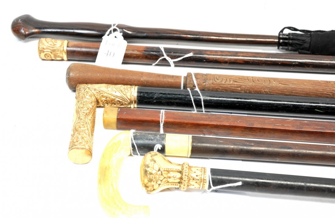 Collection of old canes T1: Three gold fill handled canes. Engraved - "Dr W.F.Hall Christmas 1888" "Marcisse Dubois" "US" Also includes three wooden canes, one has a nice ivory handle, and one umbrella, (complete without holes)