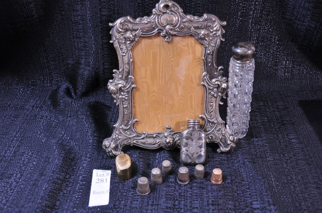 Collection of Sterling items SC1: to include a Gorham Sterling Picture Frame, two Sterling and glass perfume bottles, sterling thimbles and more