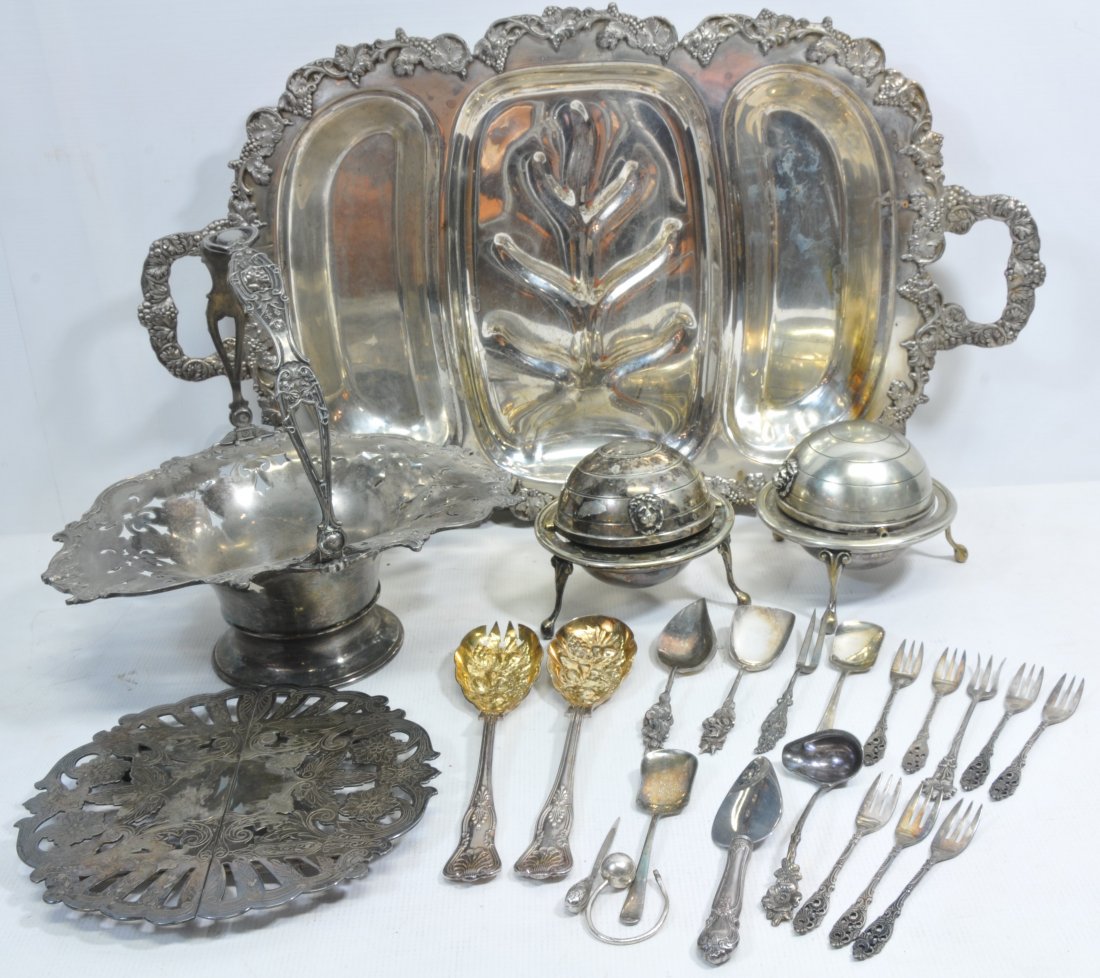 Silver Plate and Misc Collection: decorated Bride's Basket, two silver plate roll top butter dishes on legs with glass insert signed William Adams England, collection of flatware and silver tray 24" in length, six Leverre spoons with 