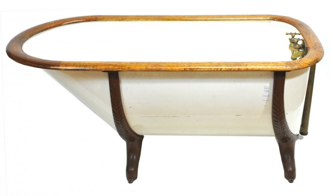 old tin bathtub with original brass fixtures and: oak trim, 53 x 26x 18.