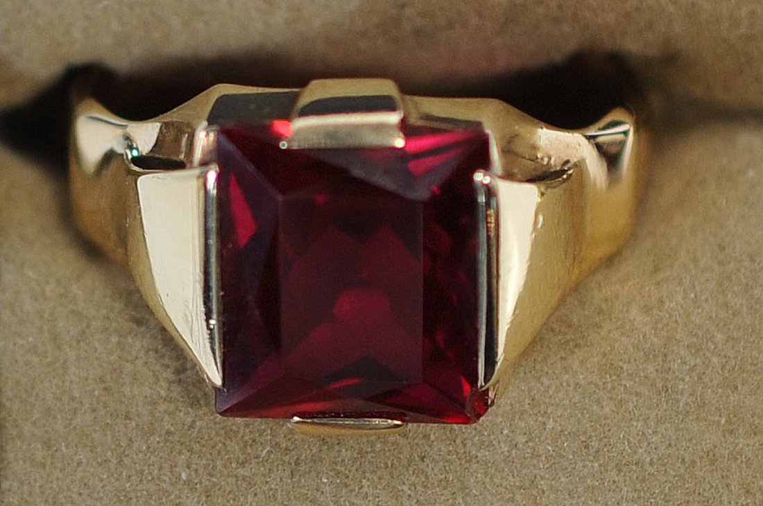 10k Yellow Gold Ruby Solitaire Gemstone Ring: 10k Yellow gold ring featuring a 12x12mm lab created ruby. This ring measures 13mm north to south from the widest points and stands 5mm off the finger. This ring weighs 4.7 grams and is currently size