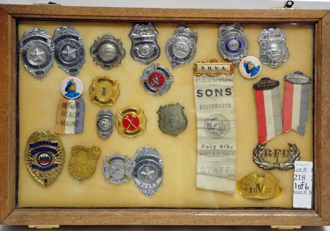 Collection of Maine Fire and Security Guard: badges in wooden case with glass to include: Lieutenant Ogunquit Fire, Falmouth, Waterville, Wells Beach, and more. Also in this collection of fire helmets from 2nd Assistant Chief C.F.D. and M.F.D., 