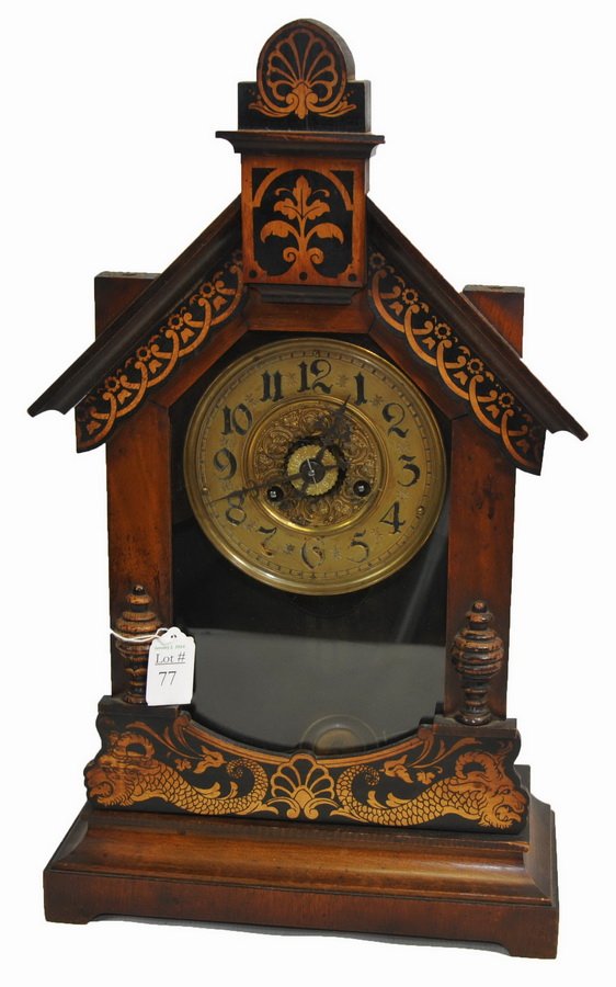 Antique shelf clock: Antique shelf clock with brass face. The front is ornately painted around the door edge. The pendulum and key are included