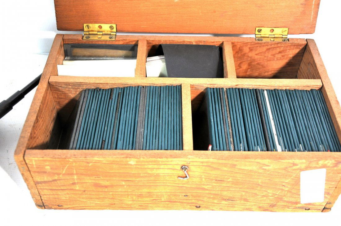 Antique slide projector: (Balopticon) made by Bausch Lomb serial no. 33337 with over 80 glass negatives in wooden carrying case. Projector is in great condition in original metal case.