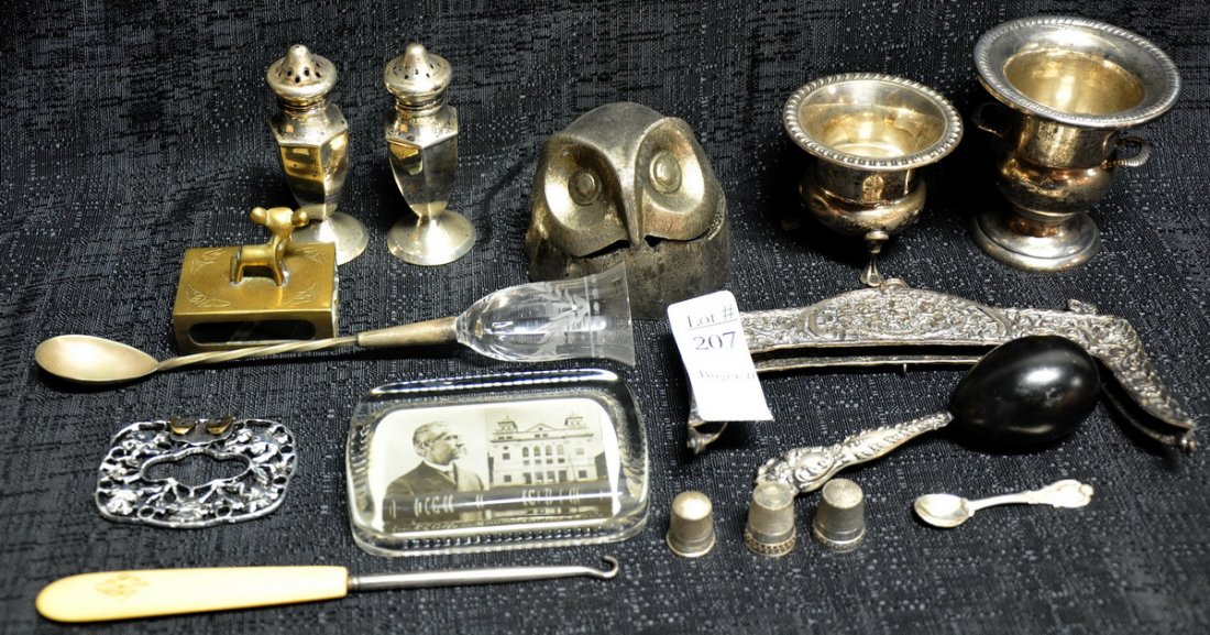 Assorted sterling silver lot: Includes, silver salt and pepper shakers, baby rattle, sewing thimbles, owls head alarm clock, baby's spoon, two small cups, and several other items.