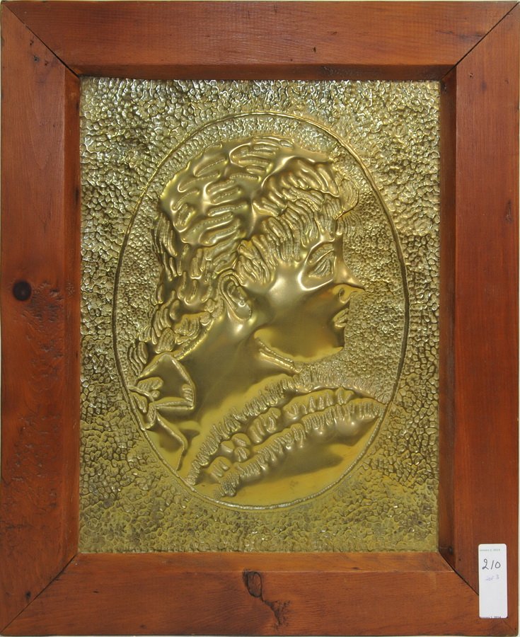Antique brass lot: Includes Antique sheet music stand, mustang folding book ends, and a brass relief 17" x 13" of a Victorian woman.